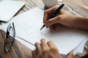 Businessman Examining Papers At Table Contabilidade Digital Online | Mv On -